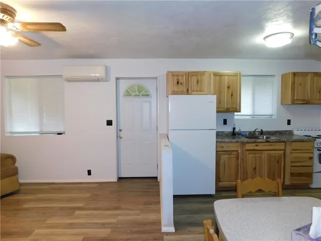 a kitchen with stainless steel appliances granite countertop a refrigerator sink and stove