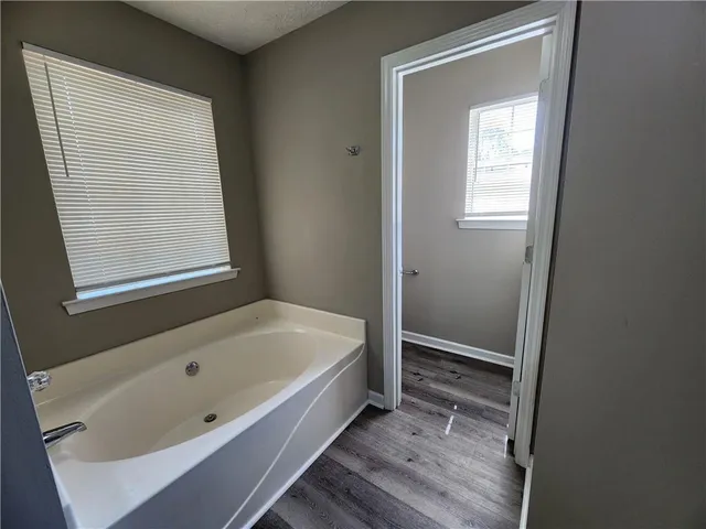 a bathroom with a tub and a window