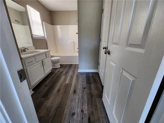 a bathroom with a sink a toilet a toilet and a window