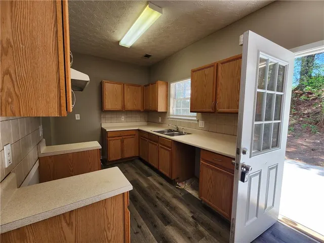 a kitchen with stainless steel appliances granite countertop a sink refrigerator and microwave