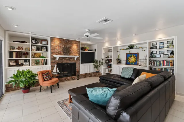 a spacious bedroom with a bed a dresser and chair