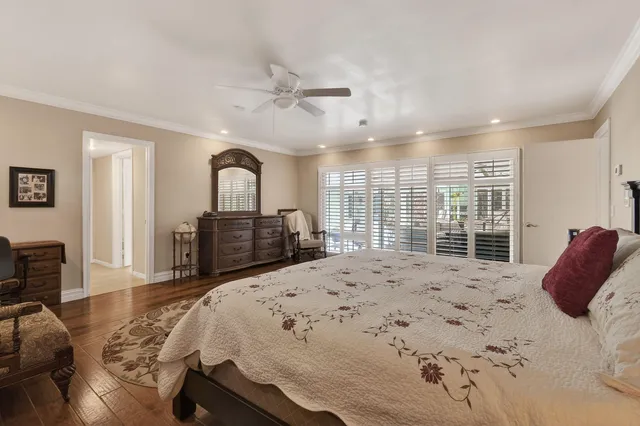 a spacious bedroom with a bed and a dresser in it