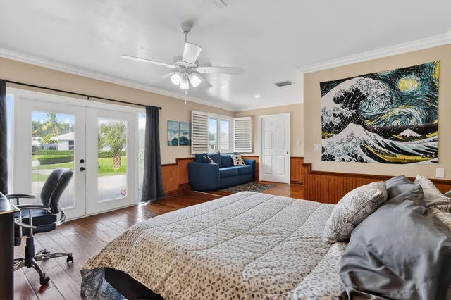 a swimming pool view with a seating space and a garden view