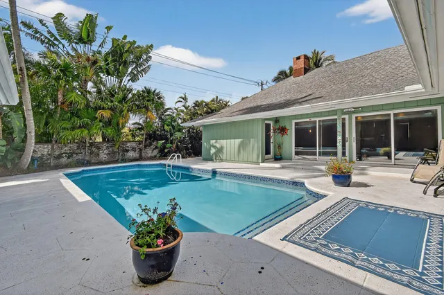 a view of a house with garden and a tree