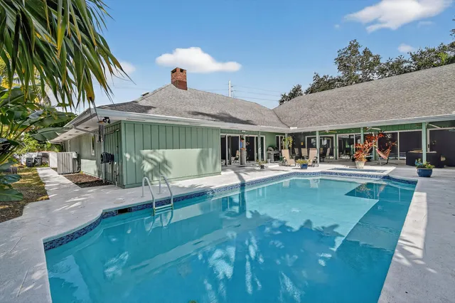 an aerial view of residential houses with outdoor space and lake view