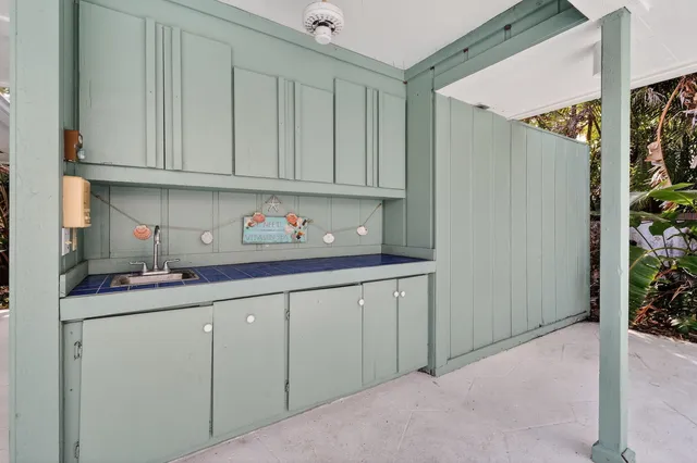 an aerial view of ocean and residential houses with outdoor space