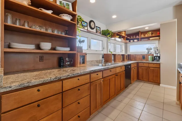 a spacious bedroom with a bed and wooden floor