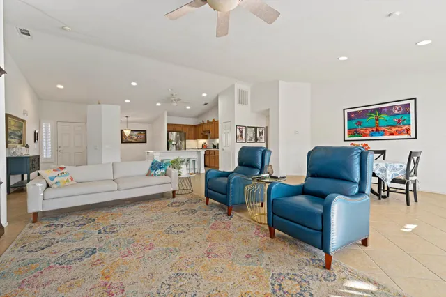 a living room with furniture and a view of kitchen