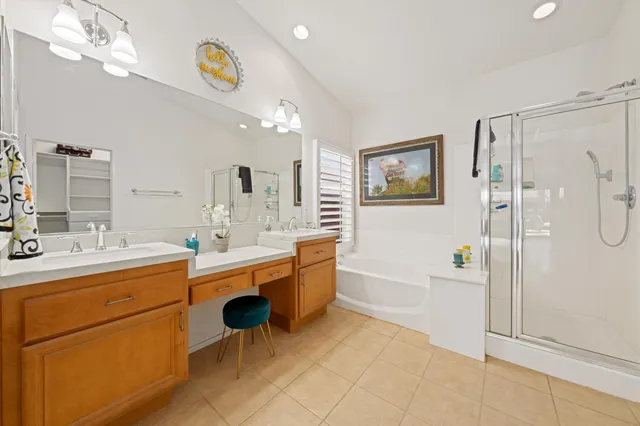 a large bathroom with a double vanity sink a mirror and a bathtub