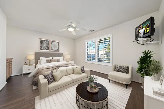 a living room with furniture a rug and a flat screen tv