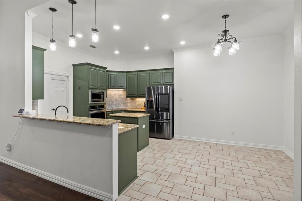 364 Preakness Place Road Van Alstyne, TX 75495 - Photo 12 of 40 a kitchen with kitchen island a sink stainless steel appliances and chandelier