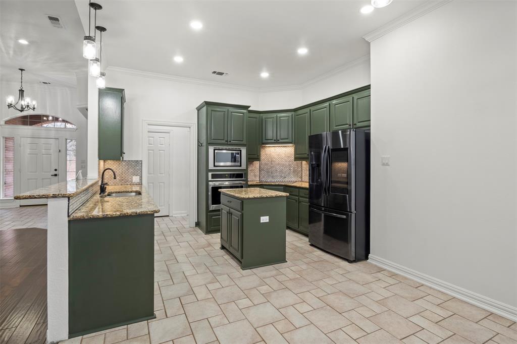 364 Preakness Place Road Van Alstyne, TX 75495 - Photo 14 of 40 a kitchen with stainless steel appliances a refrigerator and a stove