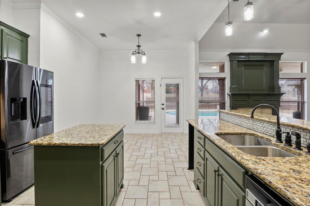364 Preakness Place Road Van Alstyne, TX 75495 - Photo 16 of 40 a kitchen with granite countertop a sink a counter top space appliances and cabinets