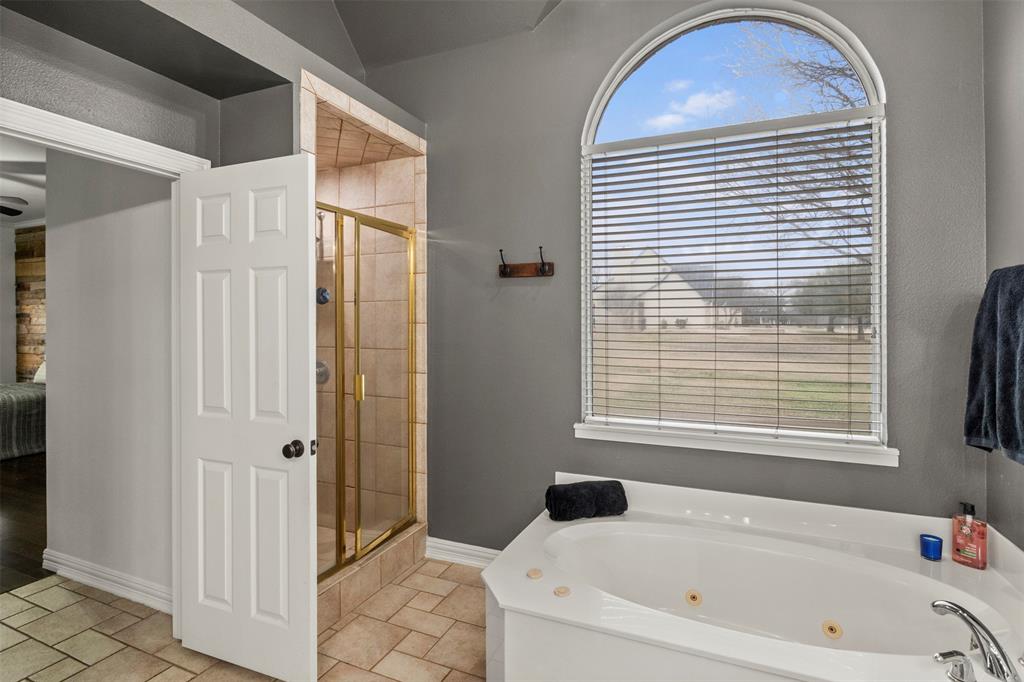 364 Preakness Place Road Van Alstyne, TX 75495 - Photo 21 of 40 a bathroom with a bathtub and a shower