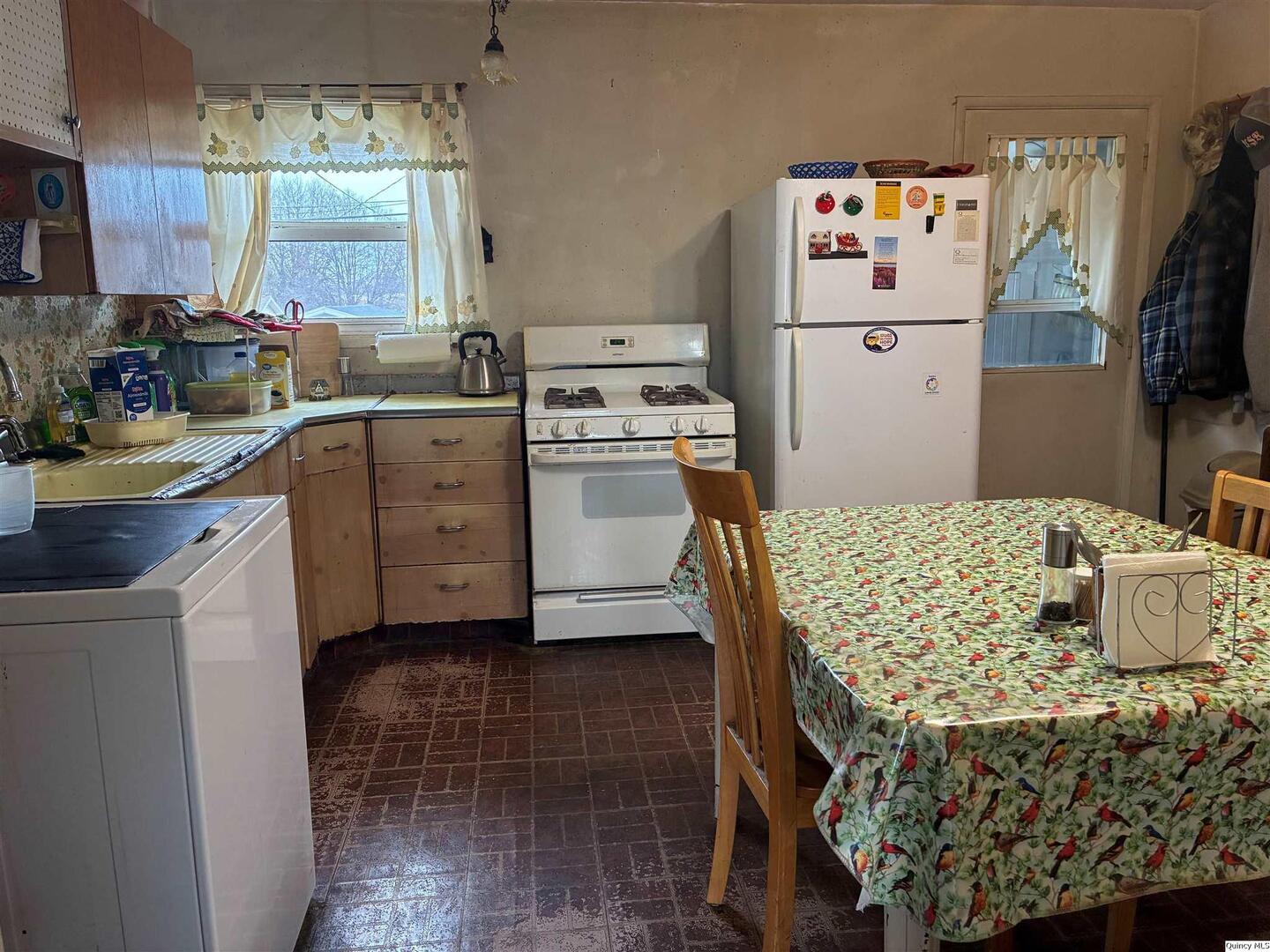 3409 Lawrence Road Quincy, IL 62301 - Photo 4 of 11 a kitchen with a sink appliances and cabinets