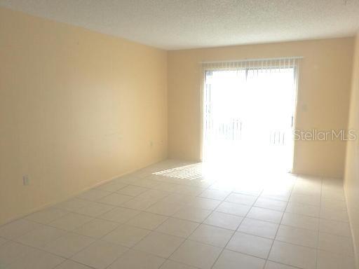 2192 Knox McRae Drive, Unit H Titusville, FL 32780 - Photo 4 of 6 a view of an empty room with a window