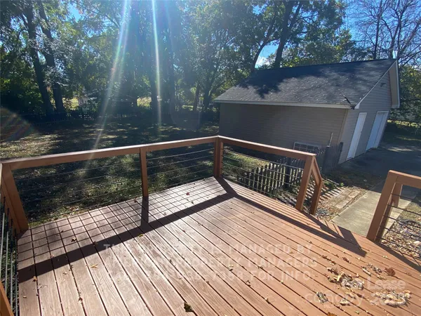 a view of deck with furniture and trees