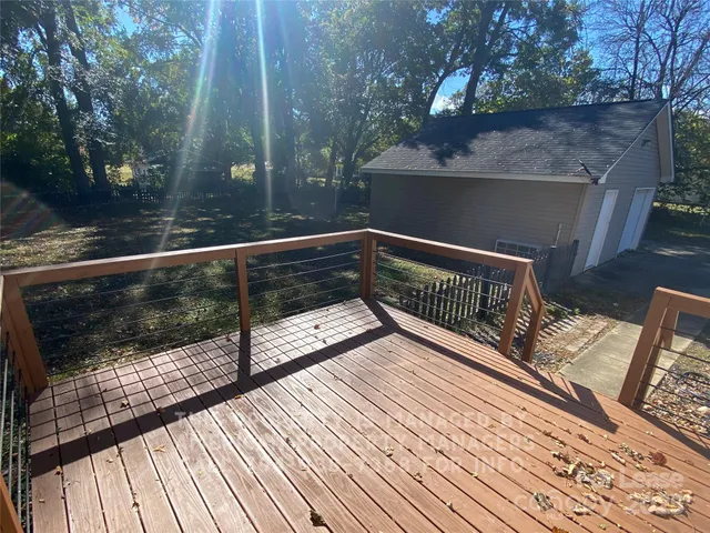 a view of deck with furniture and trees