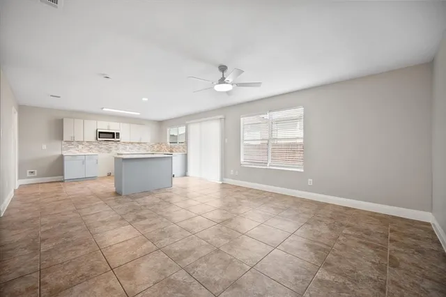 a view of kitchen with stove cabinets and entryway