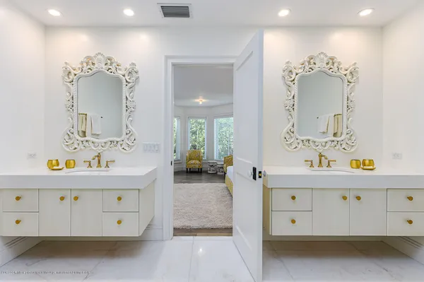 a bathroom with a sink mirror and window