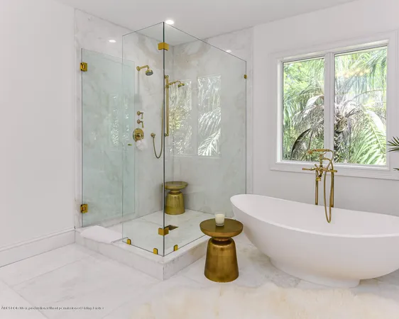 a bathroom with a tub a window and a shower
