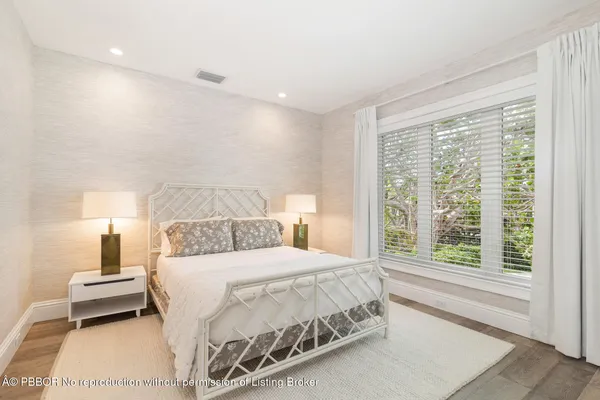 a bedroom with a bed and a night stand