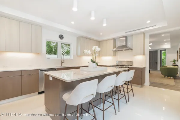 a kitchen with granite countertop a sink and white appliances