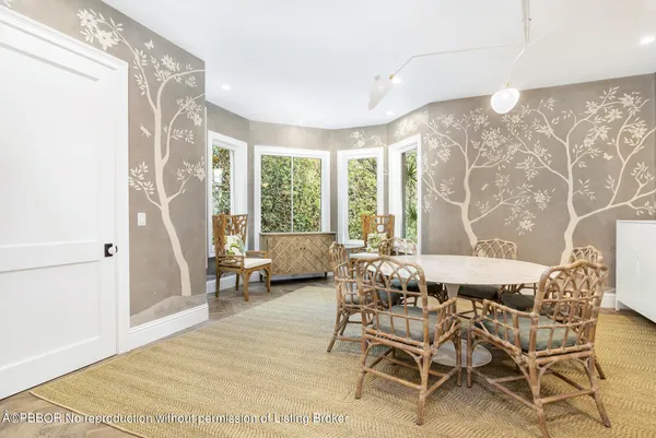 a dining room with furniture and a large window