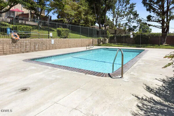 a view of a tennis ground with large trees