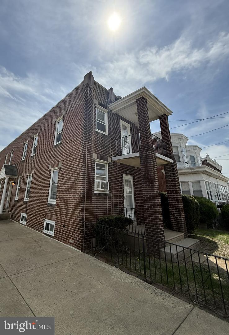 5223 Jackson Street, Unit 2F Philadelphia, PA 19124 - Photo 11 of 12 a front view of a house with parking area