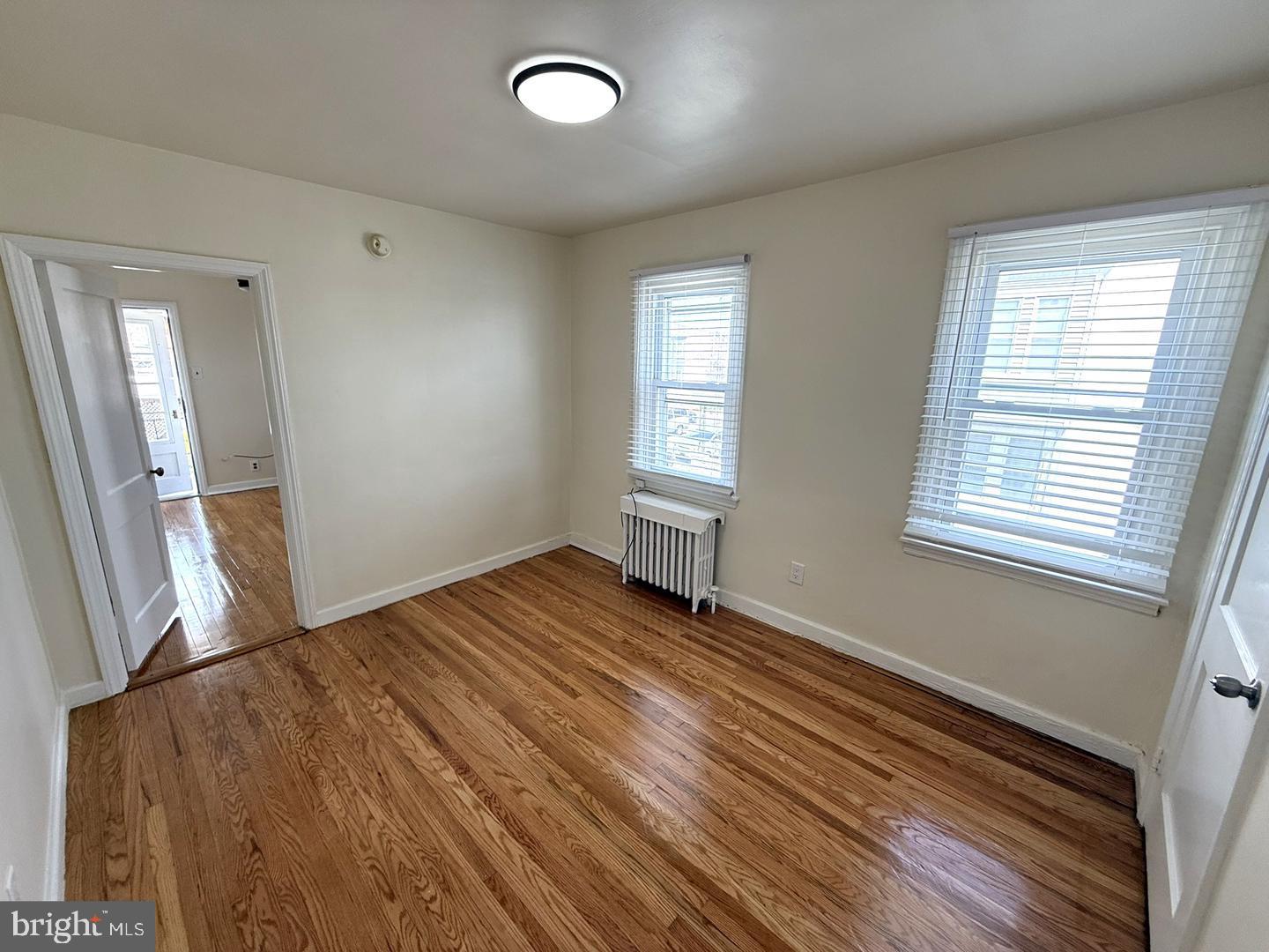 5223 Jackson Street, Unit 2F Philadelphia, PA 19124 - Photo 2 of 12 a view of an empty room with wooden floor and a window