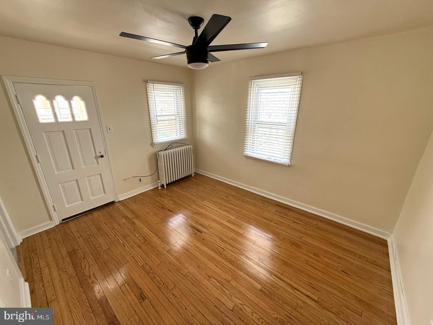 5223 Jackson Street, Unit 2F Philadelphia, PA 19124 - Photo 4 of 12 an empty room with wooden floor and windows