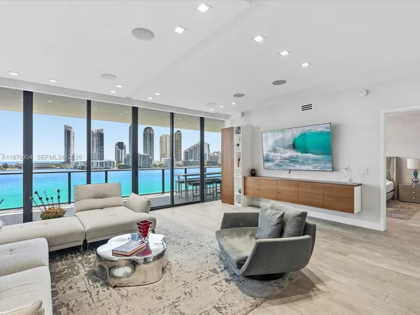 a living room with furniture and a floor to ceiling window