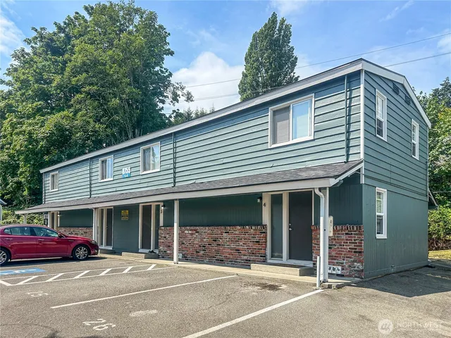 a front view of a house with a garden and garage