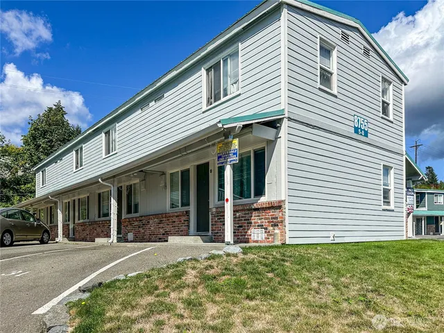 a front view of a house with a garden