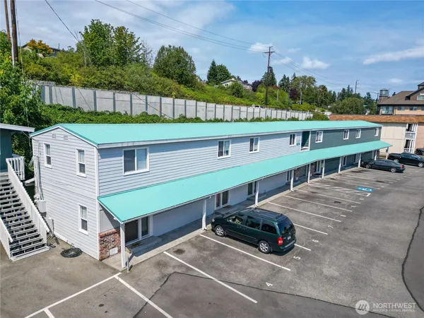 a car parked in front of a house with a yard