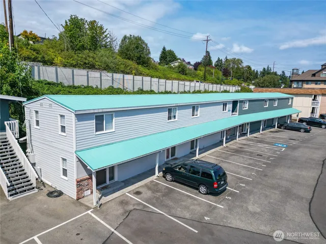 a car parked in front of a house with a yard