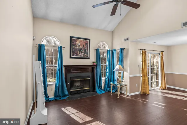 a view of an empty room with stairs and a fireplace