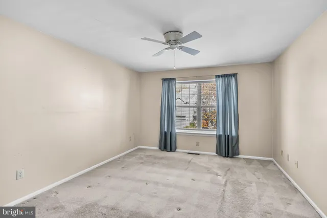 a view of a room with a ceiling fan