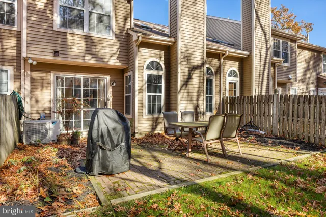 a view of a chairs and table in the back yard of the house