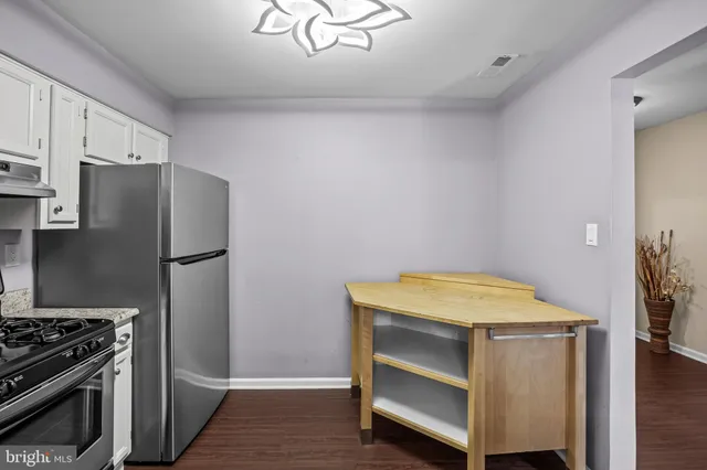 a kitchen with a stove and a refrigerator