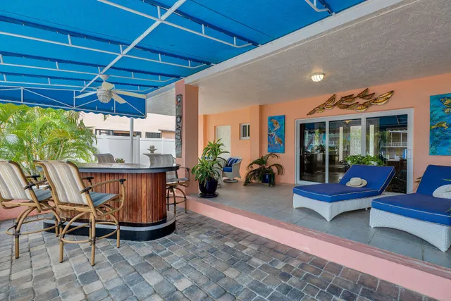 an aerial view of a city with lots of residential buildings and ocean view in back