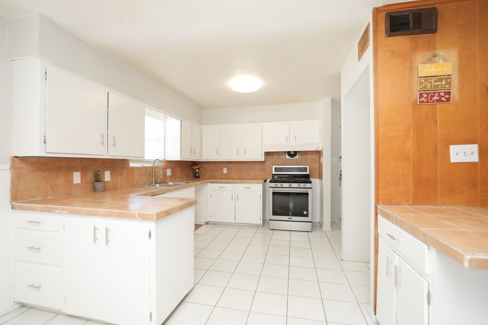 8235 Dover Street Houston, TX 77061 - Photo 14 of 36 a kitchen with a sink cabinets and appliances