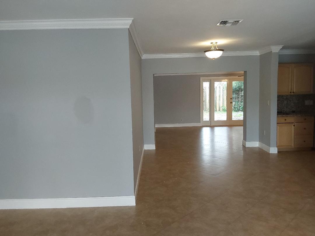98 Seminole Lane Boca Raton, FL 33487 - Photo 38 of 42 a view of an empty room with window and wooden floor