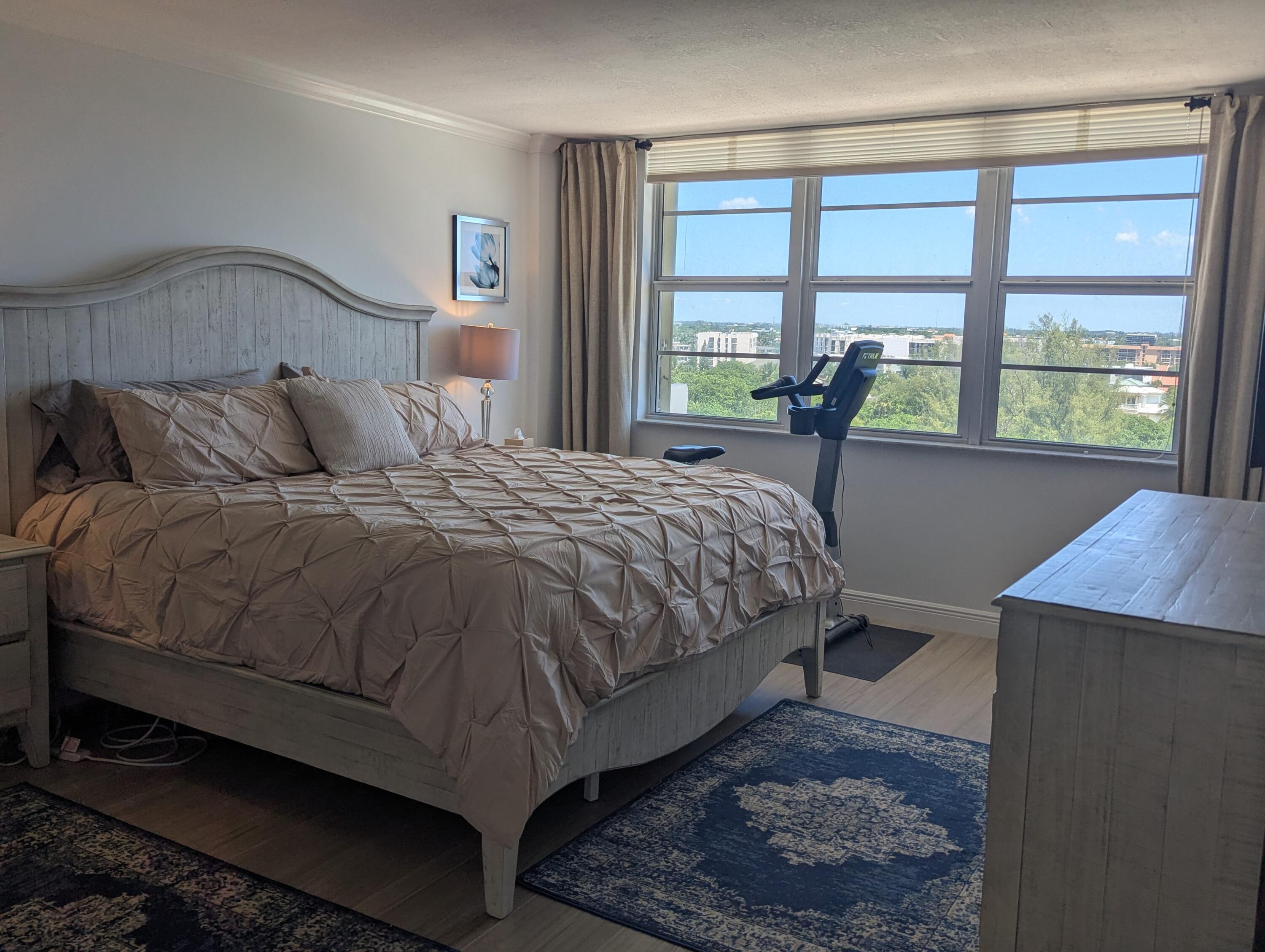 2121 North Ocean Boulevard, Unit 1006E Boca Raton, FL 33431 - Photo 21 of 64 a large bed sitting in a bedroom next to a window