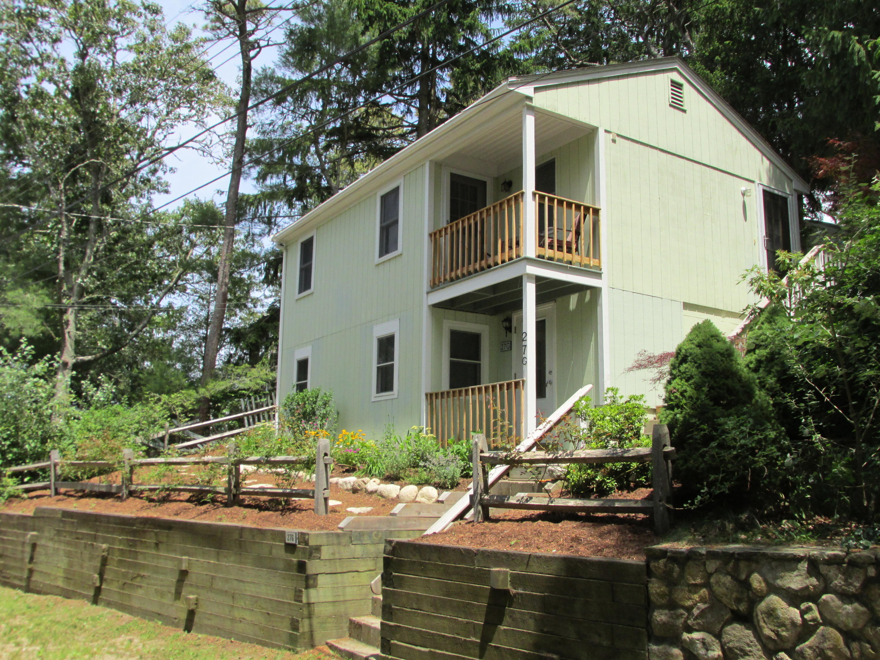 27 Hideaway Road, Unit G Buzzards Bay, MA 02532 - Photo 1 of 34 a house with trees in front of it