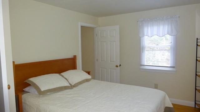 27 Hideaway Road, Unit G Buzzards Bay, MA 02532 - Photo 13 of 34 a bedroom with a bed and window