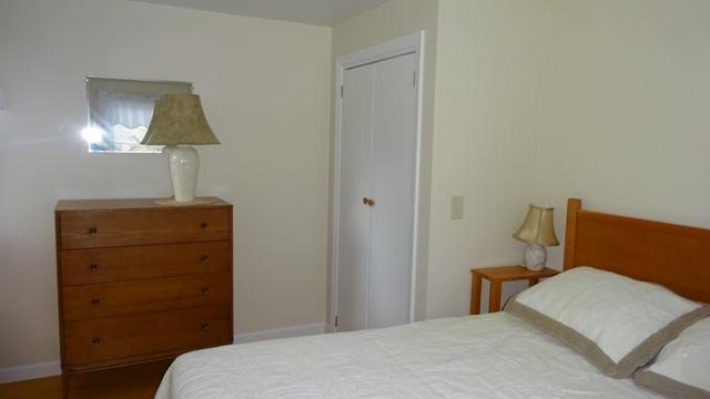 27 Hideaway Road, Unit G Buzzards Bay, MA 02532 - Photo 14 of 34 a bedroom with a bed and a lamp