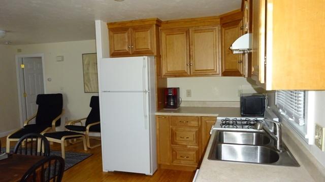 27 Hideaway Road, Unit G Buzzards Bay, MA 02532 - Photo 5 of 34 a kitchen with a refrigerator and a stove top oven