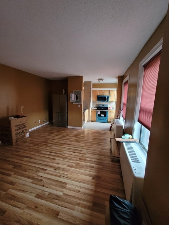 140 Chestnut Street, Unit 715 Springfield, MA 01103 - Photo 5 of 13 a room with furniture and a fireplace